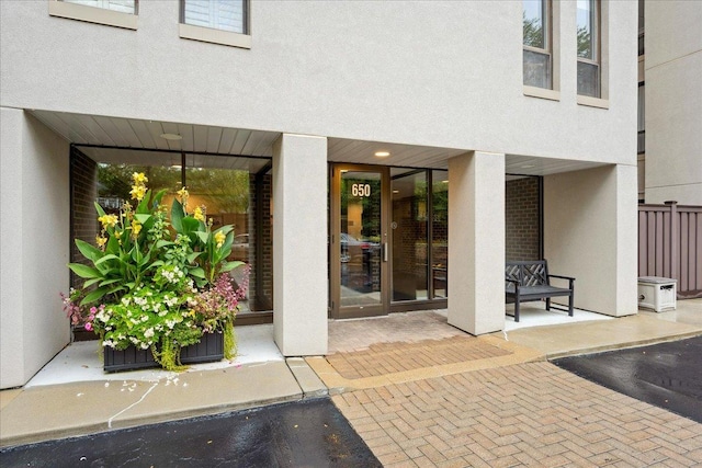 650 Winnetka Mews Unit 311, Winnetka, IL 60093 - doorway to property featuring stucco siding and a patio area