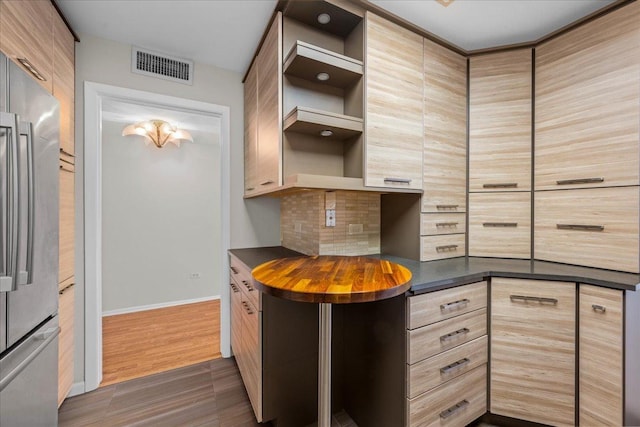 650 Winnetka Mews Unit 311, Winnetka, IL 60093 - kitchen with open shelves, stainless steel fridge, tasteful backsplash, light brown cabinets, and dark wood-style floors