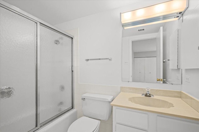 650 Winnetka Mews Unit 311, Winnetka, IL 60093 - full bath with vanity, tile walls, combined bath / shower with glass door, and wainscoting