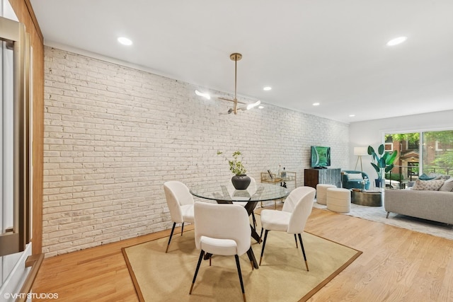 636 W Buckingham Pl Unit C, Chicago, IL 60657 - dining space featuring brick wall, light wood finished floors, and recessed lighting
