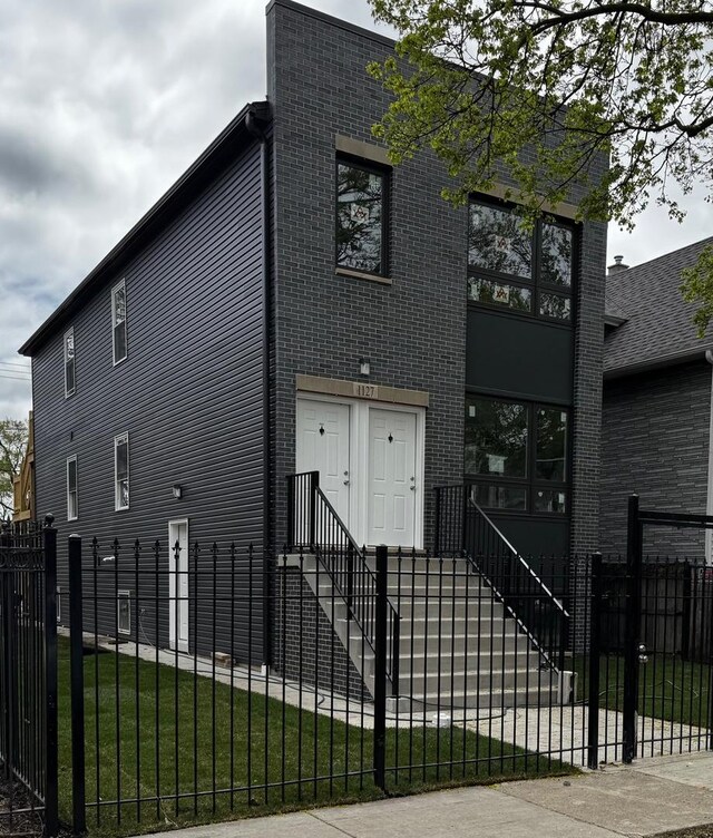 4256 W Augusta Blvd, Chicago, IL 60651 - view of front of home with a fenced front yard and brick siding