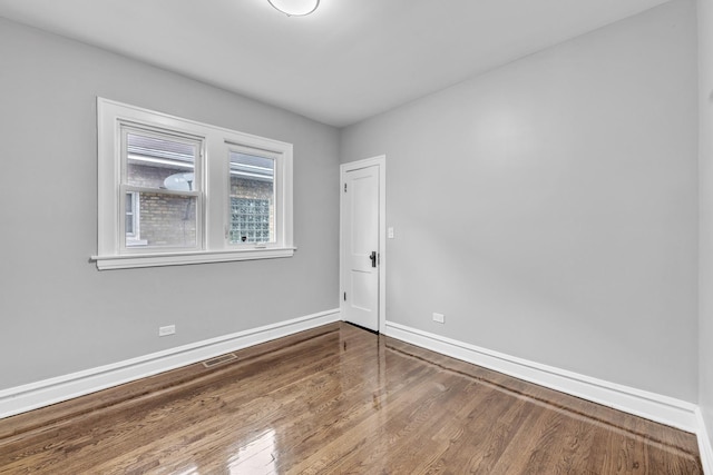 2107 E Ave, Berwyn, IL 60402 - spare room featuring baseboards and wood finished floors