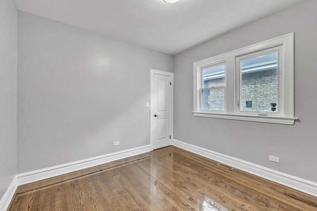 2107 E Ave, Berwyn, IL 60402 - unfurnished room with baseboards and wood finished floors