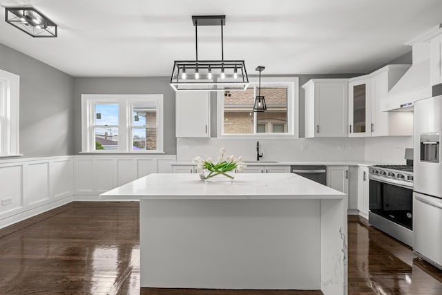 2107 E Ave, Berwyn, IL 60402 - kitchen with appliances with stainless steel finishes, dark wood-type flooring, white cabinetry, glass insert cabinets, and decorative backsplash