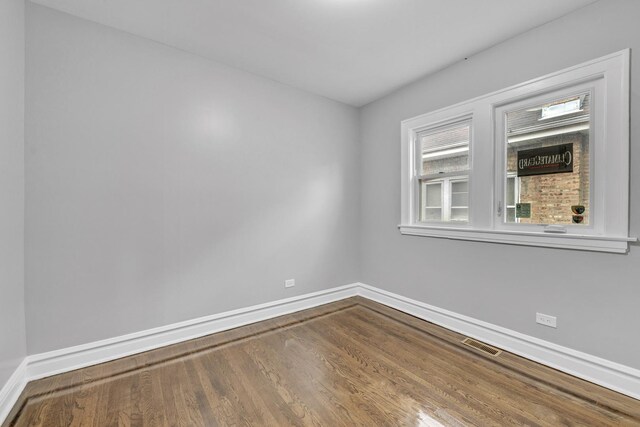 2107 E Ave, Berwyn, IL 60402 - spare room featuring wood finished floors and baseboards
