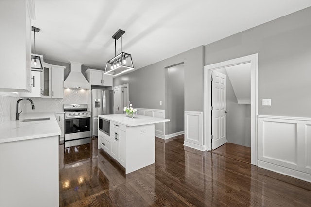 2107 E Ave, Berwyn, IL 60402 - kitchen featuring appliances with stainless steel finishes, custom range hood, dark wood finished floors, a decorative wall, and a center island