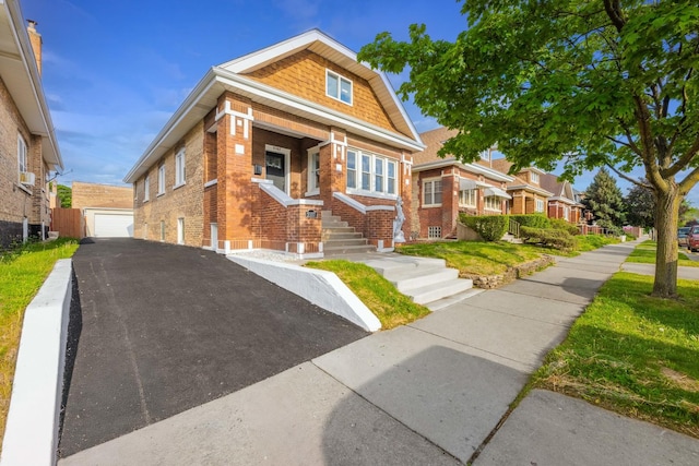 2107 E Ave, Berwyn, IL 60402 - bungalow-style house featuring brick siding, a garage, a porch, an outdoor structure, and a residential view