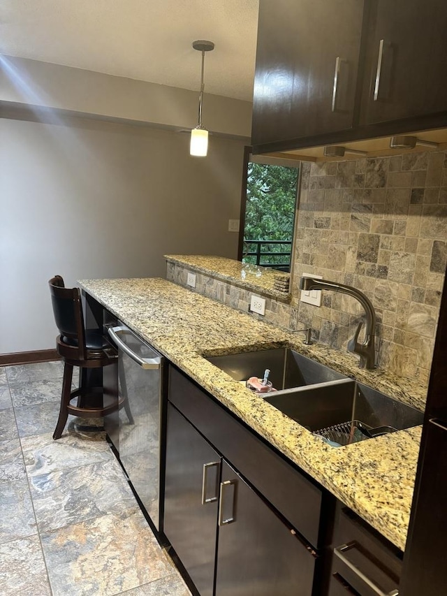 1017 Buccaneer Dr Unit 5, Schaumburg, IL 60173 - kitchen with dark brown cabinetry, decorative backsplash, and stainless steel dishwasher