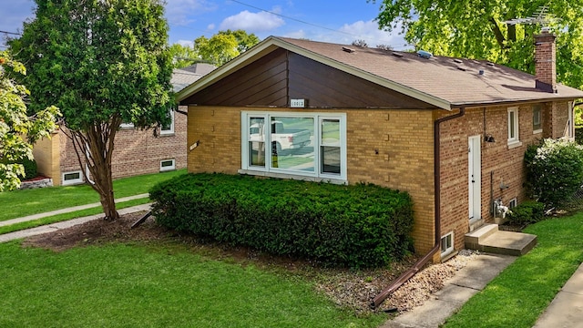 10012 S 52nd Ave, Oak Lawn, IL 60453 - view of side of home with entry steps, brick siding, a chimney, and a lawn