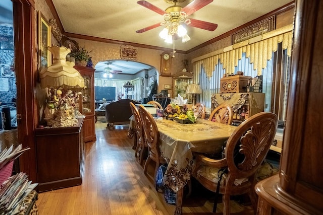 4830 W Oakdale Ave, Chicago, IL 60641 - dining space with a ceiling fan, wood finished floors, ornamental molding, and arched walkways