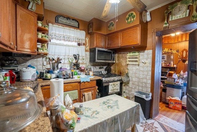 4830 W Oakdale Ave, Chicago, IL 60641 - kitchen with stainless steel appliances, brown cabinetry, light countertops, and decorative backsplash