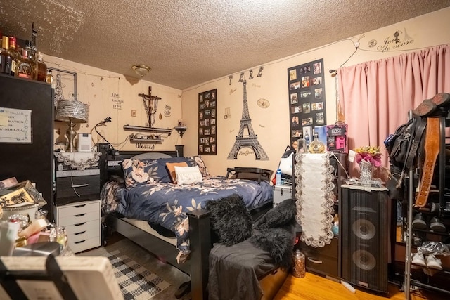 4830 W Oakdale Ave, Chicago, IL 60641 - bedroom with a textured ceiling and wood finished floors
