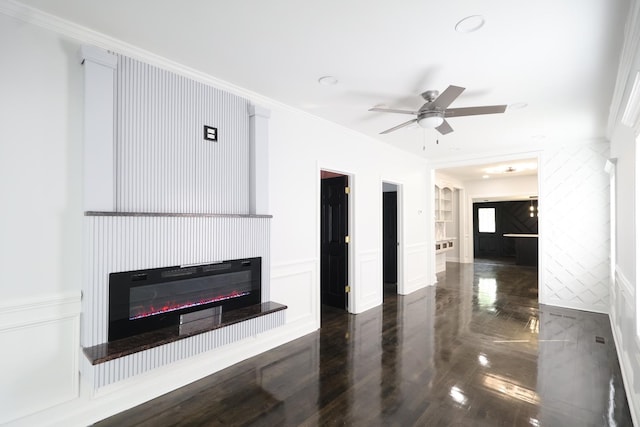 15239 Vincennes Rd, Phoenix, IL 60426 - unfurnished living room featuring ornamental molding, a decorative wall, a ceiling fan, a glass covered fireplace, and wainscoting