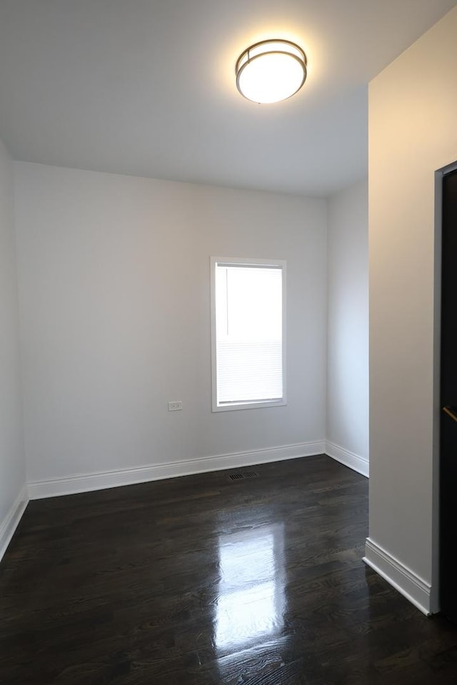 15239 Vincennes Rd, Phoenix, IL 60426 - spare room featuring baseboards and dark wood finished floors