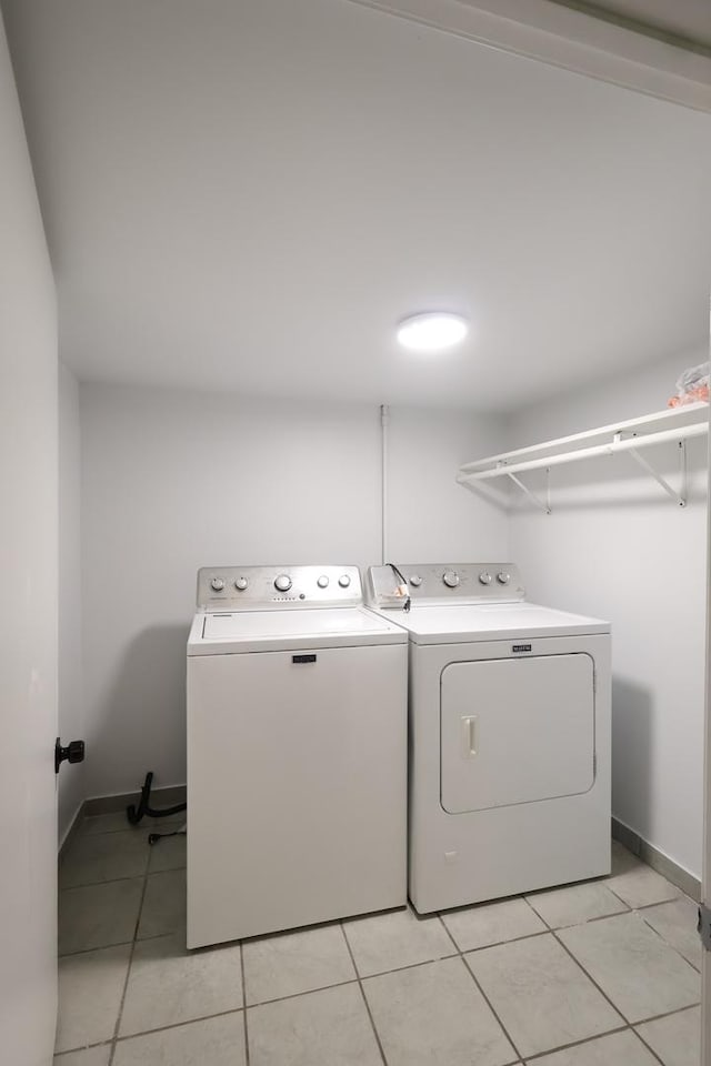 15239 Vincennes Rd, Phoenix, IL 60426 - laundry room with washer and dryer and light tile patterned floors