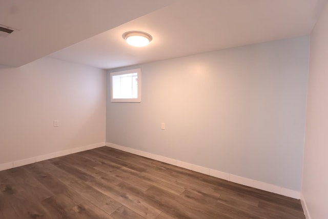 15239 Vincennes Rd, Phoenix, IL 60426 - below grade area featuring dark wood-style flooring and baseboards