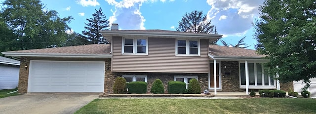 611 Kungs Way, Joliet, IL 60435 - tri-level home featuring concrete driveway, a chimney, an attached garage, a front yard, and brick siding