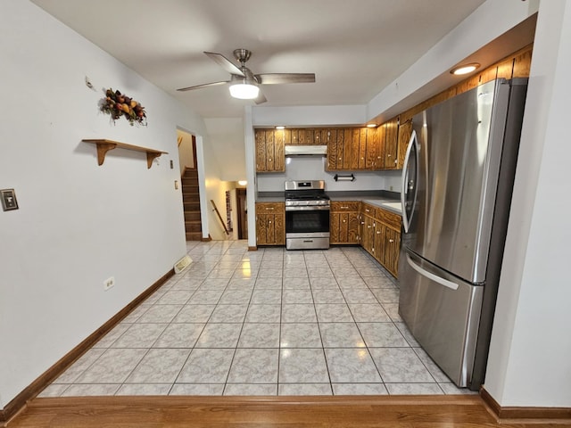 611 Kungs Way, Joliet, IL 60435 - kitchen with appliances with stainless steel finishes, under cabinet range hood, a ceiling fan, brown cabinets, and light tile patterned flooring