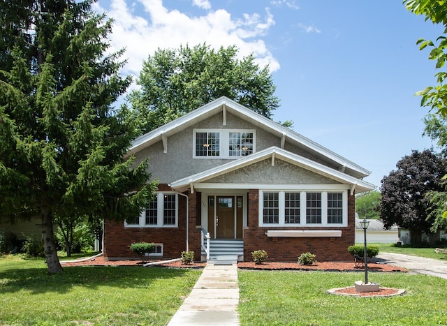 224 N Maple St, Gilman, IL 60938 - view of front facade with brick siding and a front lawn