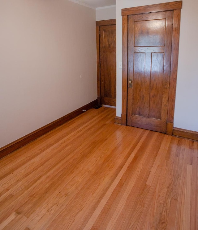 224 N Maple St, Gilman, IL 60938 - unfurnished bedroom with ornamental molding and light wood-type flooring