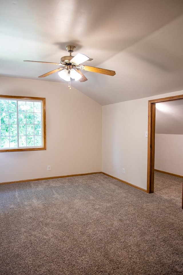 224 N Maple St, Gilman, IL 60938 - empty room featuring carpet, lofted ceiling, and a ceiling fan
