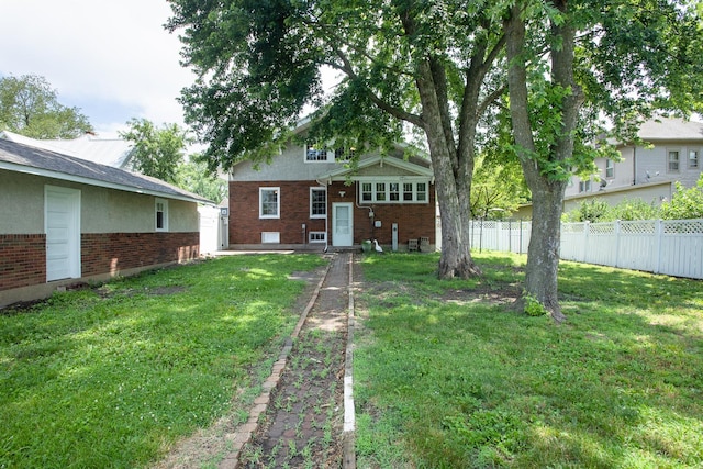 224 N Maple St, Gilman, IL 60938 - rear view of property featuring brick siding