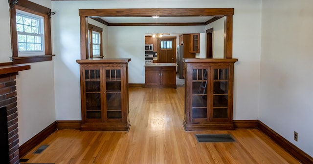 224 N Maple St, Gilman, IL 60938 - hall featuring light wood-style flooring and ornamental molding