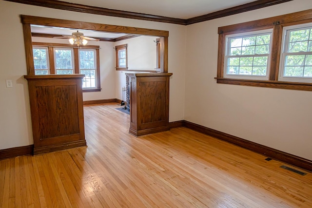224 N Maple St, Gilman, IL 60938 - unfurnished room featuring plenty of natural light, light wood-type flooring, ornamental molding, and ceiling fan