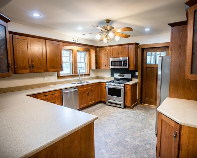 224 N Maple St, Gilman, IL 60938 - kitchen with appliances with stainless steel finishes, brown cabinetry, a ceiling fan, light countertops, and recessed lighting
