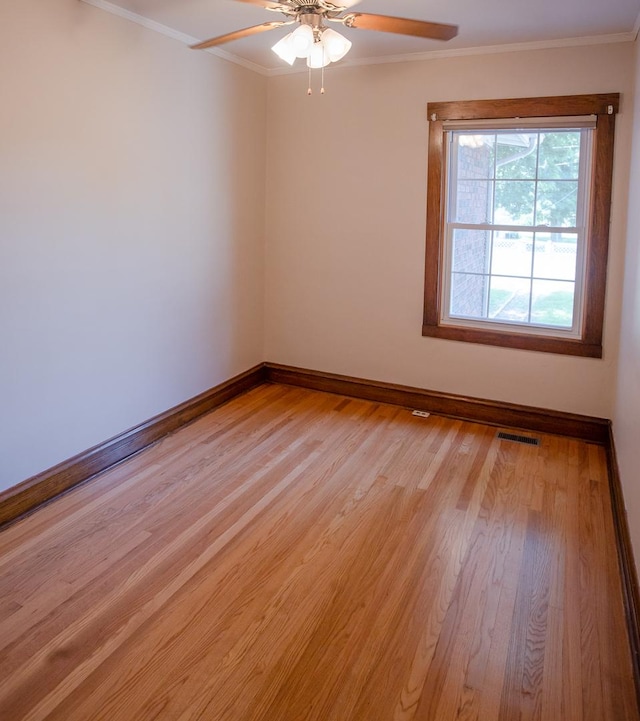 224 N Maple St, Gilman, IL 60938 - spare room featuring light wood-type flooring, ceiling fan, and ornamental molding