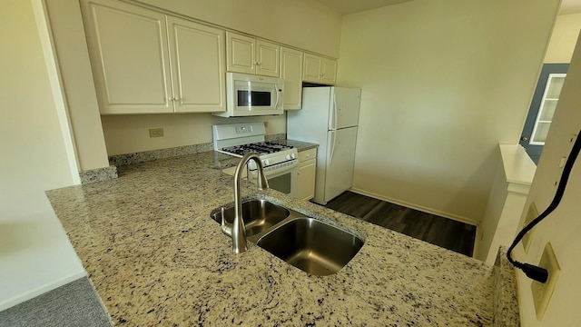 17885 W Salisbury Dr, Gurnee, IL 60031 - kitchen with white appliances, light stone countertops, a peninsula, white cabinets, and dark wood-style floors