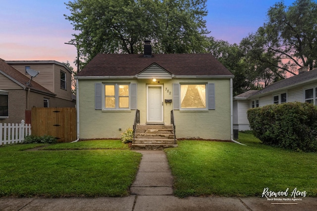 382 N 8th Ave, Kankakee, IL 60901 - bungalow featuring stucco siding, roof with shingles, and entry steps