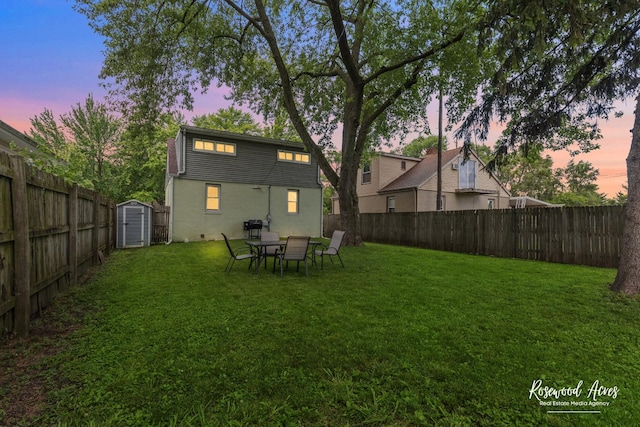 382 N 8th Ave, Kankakee, IL 60901 - back of house at dusk featuring a fenced backyard and a shed