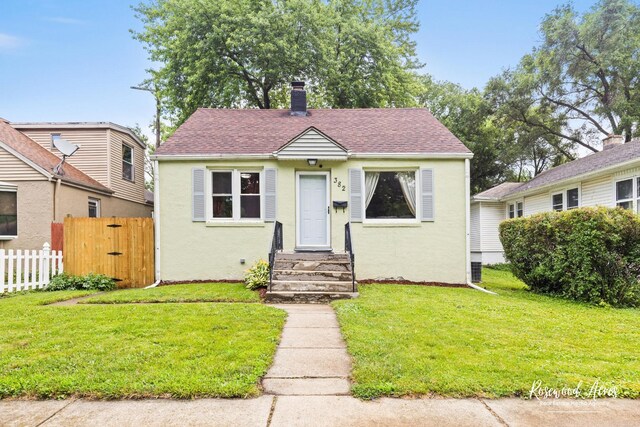 382 N 8th Ave, Kankakee, IL 60901 - bungalow-style house featuring stucco siding, a chimney, and a shingled roof