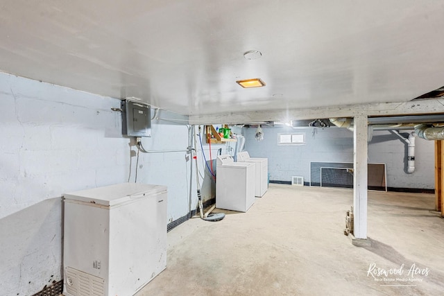 382 N 8th Ave, Kankakee, IL 60901 - below grade area featuring washer and clothes dryer, white fridge, and electric panel