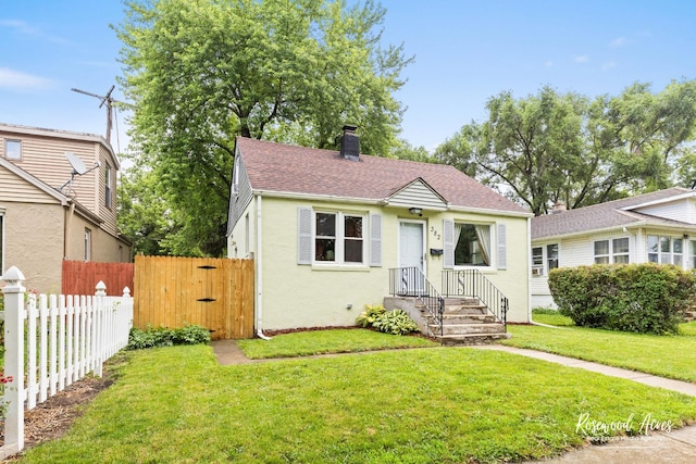382 N 8th Ave, Kankakee, IL 60901 - bungalow-style house with roof with shingles, a chimney, and stucco siding