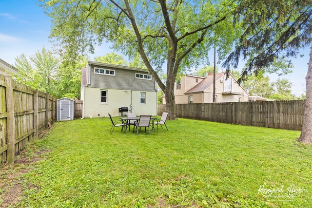 382 N 8th Ave, Kankakee, IL 60901 - back of house featuring a fenced backyard, a storage shed, and stucco siding