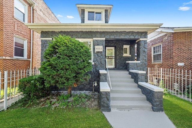 view of front facade with a porch and stone siding