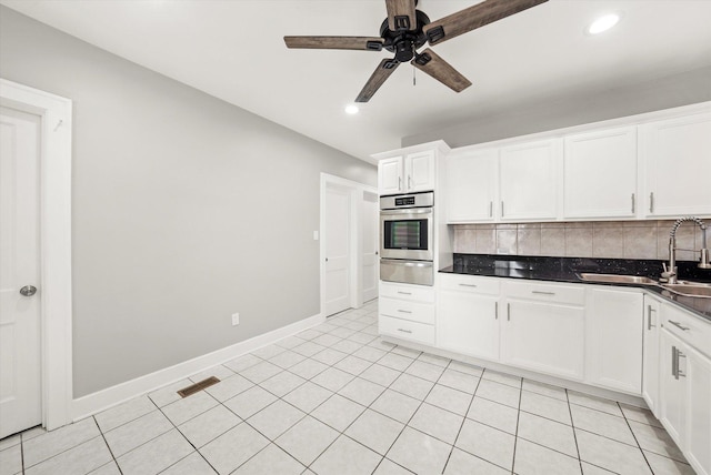 kitchen with oven, a warming drawer, decorative backsplash, ceiling fan, and recessed lighting