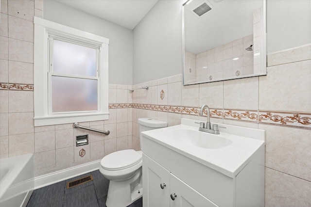 full bathroom featuring tile walls, vanity, a bath, and a shower
