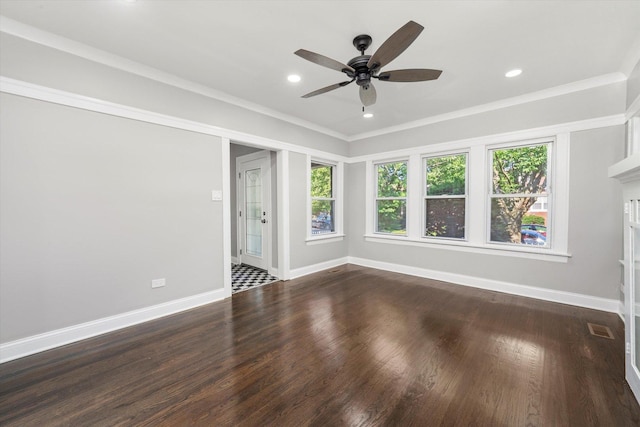 empty room featuring plenty of natural light, a ceiling fan, wood finished floors, recessed lighting, and crown molding