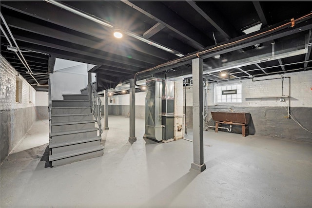 basement with heating unit and stairs