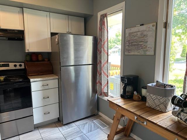 903 N Linden St Unit 3, Normal, IL 61761 - kitchen featuring appliances with stainless steel finishes, range hood, and white cabinetry