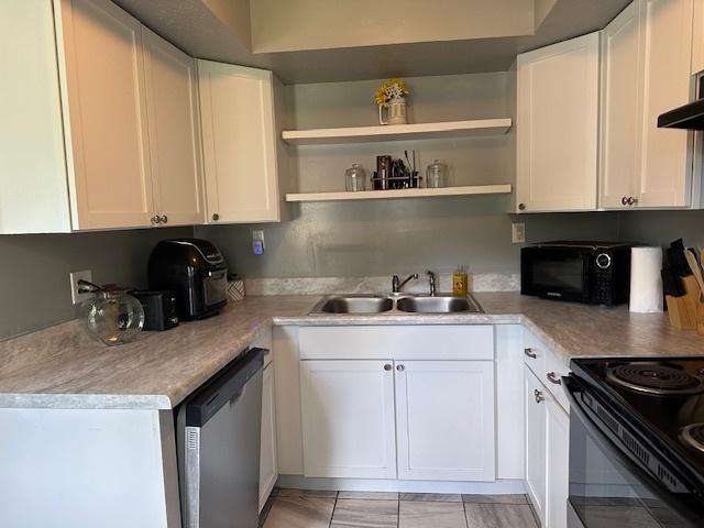 903 N Linden St Unit 3, Normal, IL 61761 - kitchen with black appliances, white cabinets, and light countertops