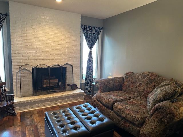 903 N Linden St Unit 3, Normal, IL 61761 - living area featuring wood finished floors, healthy amount of natural light, and a brick fireplace