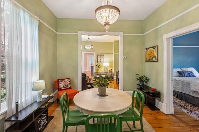 1422 Wesley Ave, Evanston, IL 60201 - dining space with wood-type flooring, healthy amount of natural light, and a chandelier