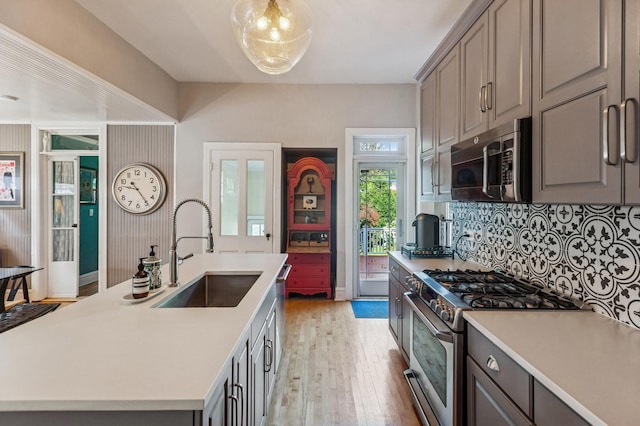 1422 Wesley Ave, Evanston, IL 60201 - kitchen with appliances with stainless steel finishes, light wood-style floors, gray cabinetry, and light countertops
