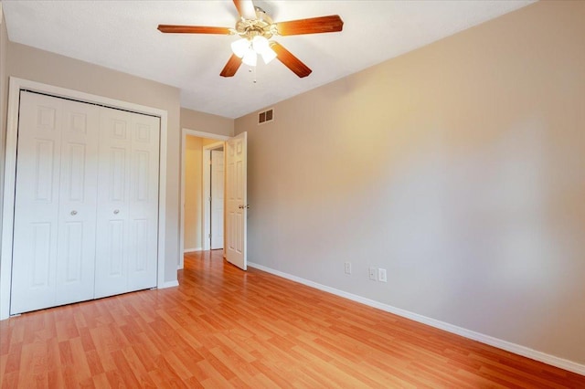 6 Starlight Ct, Bloomington, IL 61704 - unfurnished bedroom featuring light wood finished floors, a closet, and ceiling fan