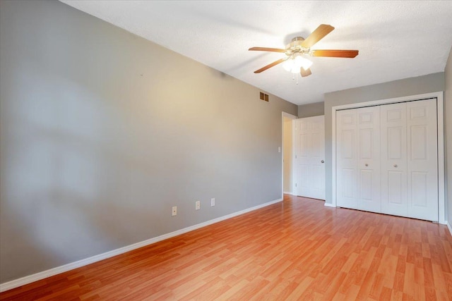 6 Starlight Ct, Bloomington, IL 61704 - unfurnished bedroom featuring light wood-style flooring, a closet, and a ceiling fan