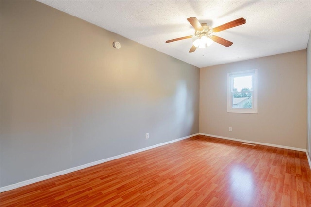 6 Starlight Ct, Bloomington, IL 61704 - spare room featuring light wood-type flooring, a ceiling fan, a smoke detector, and a textured ceiling